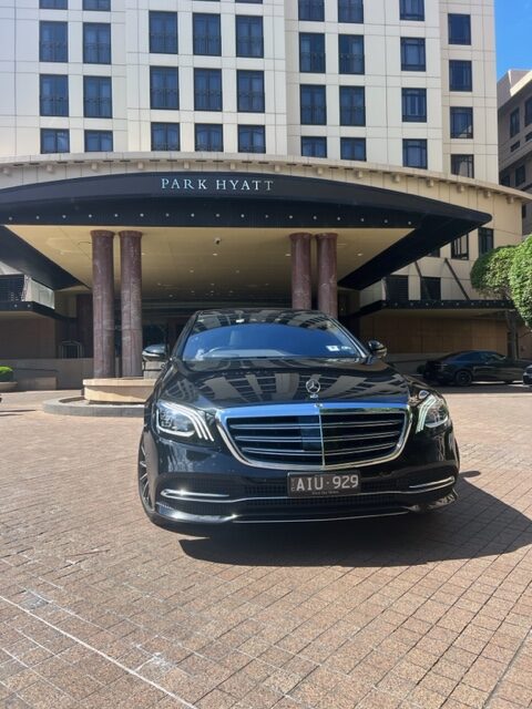 Black Mercedes S Class in front of a hotel - VHA cars Melbourne